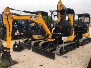 Yellow and black JCB mini excavators with buckets and dozer blades lined up for rent at 4-T Rental & Sales