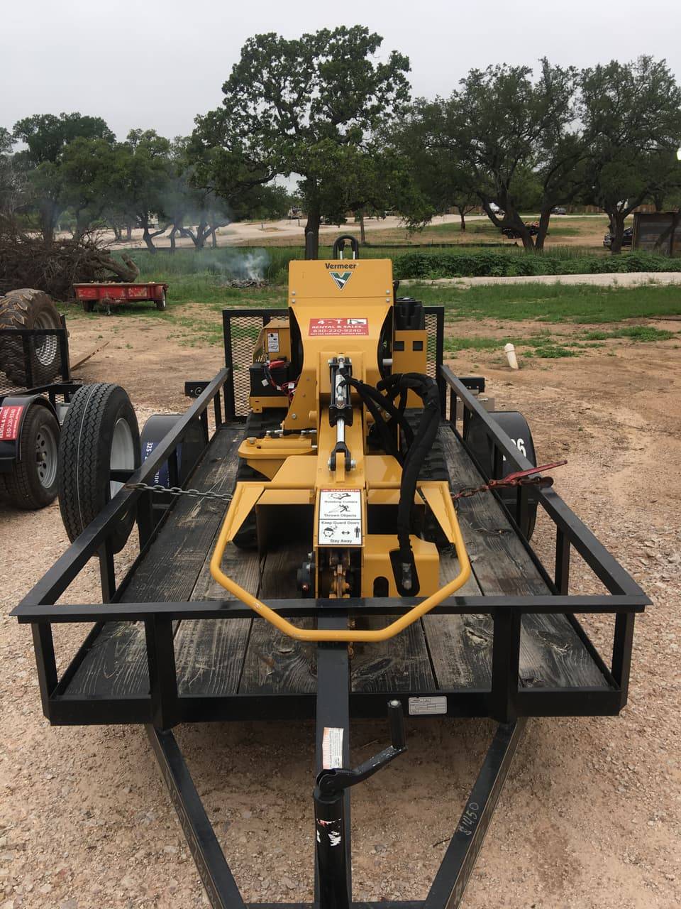 Vermeer track trencher chained to a trailer, front view