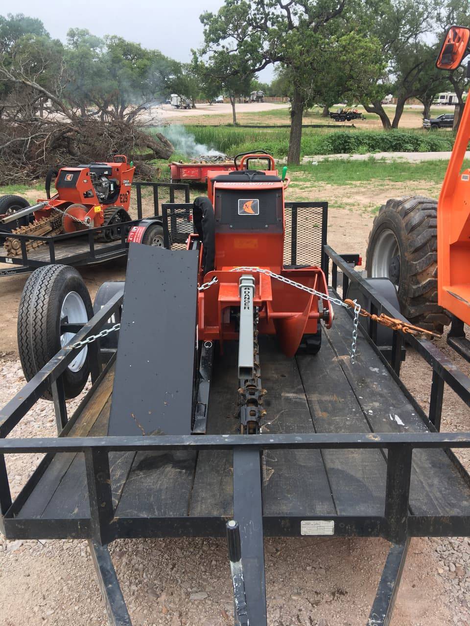 Ditch Witch trencher on a trailer with a second trencher behind it