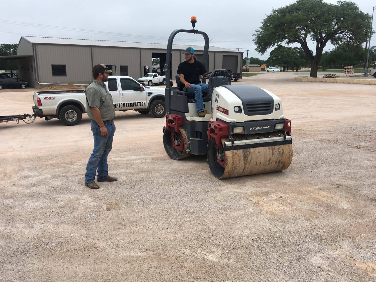 Dynapac CC1200 VI double-drum roller with 4-T team members on the yard
